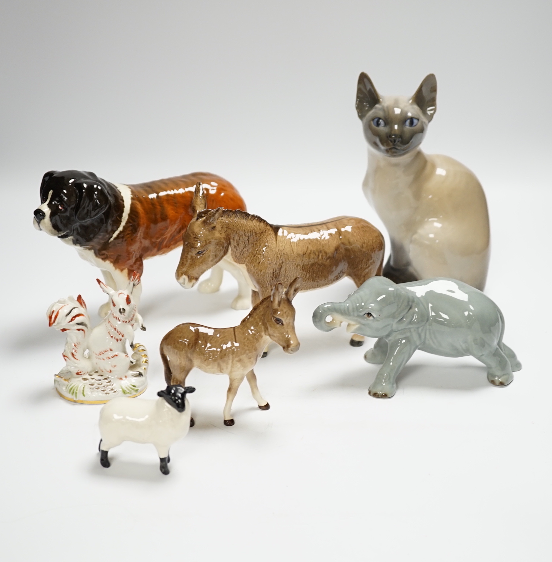 Eight animals including four Beswick, a Szeiler, a Royal Copenhagen, a cast metal cat and a Schierhols and Sohn, tallest 19.5cm